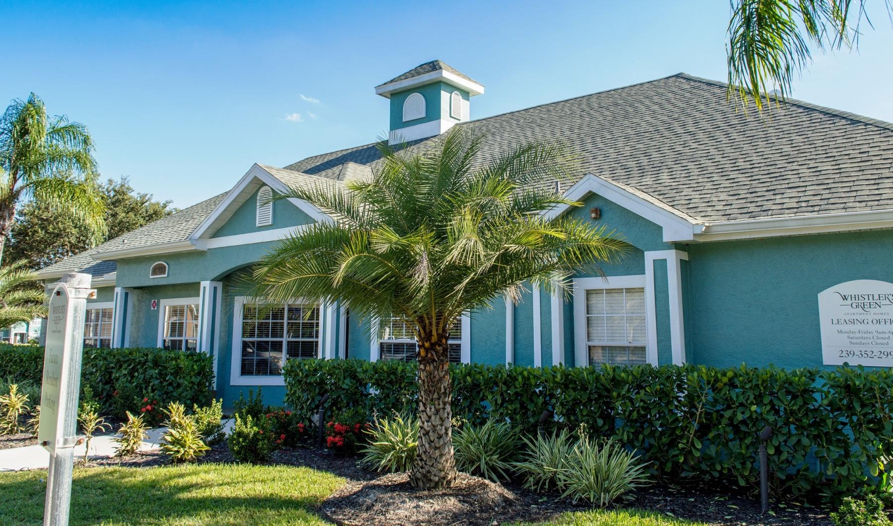 leasing office exterior with palm trees
