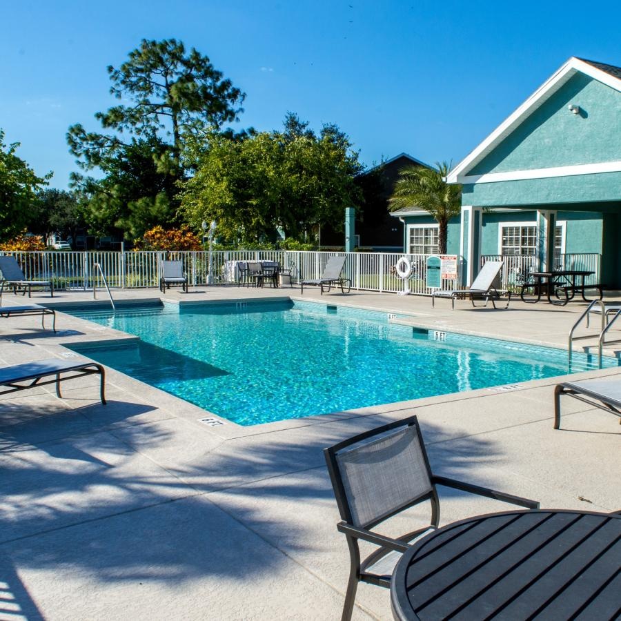 a swimming pool with chairs around it
