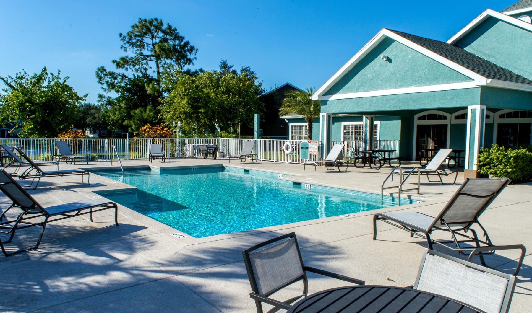 a swimming pool with chairs around it